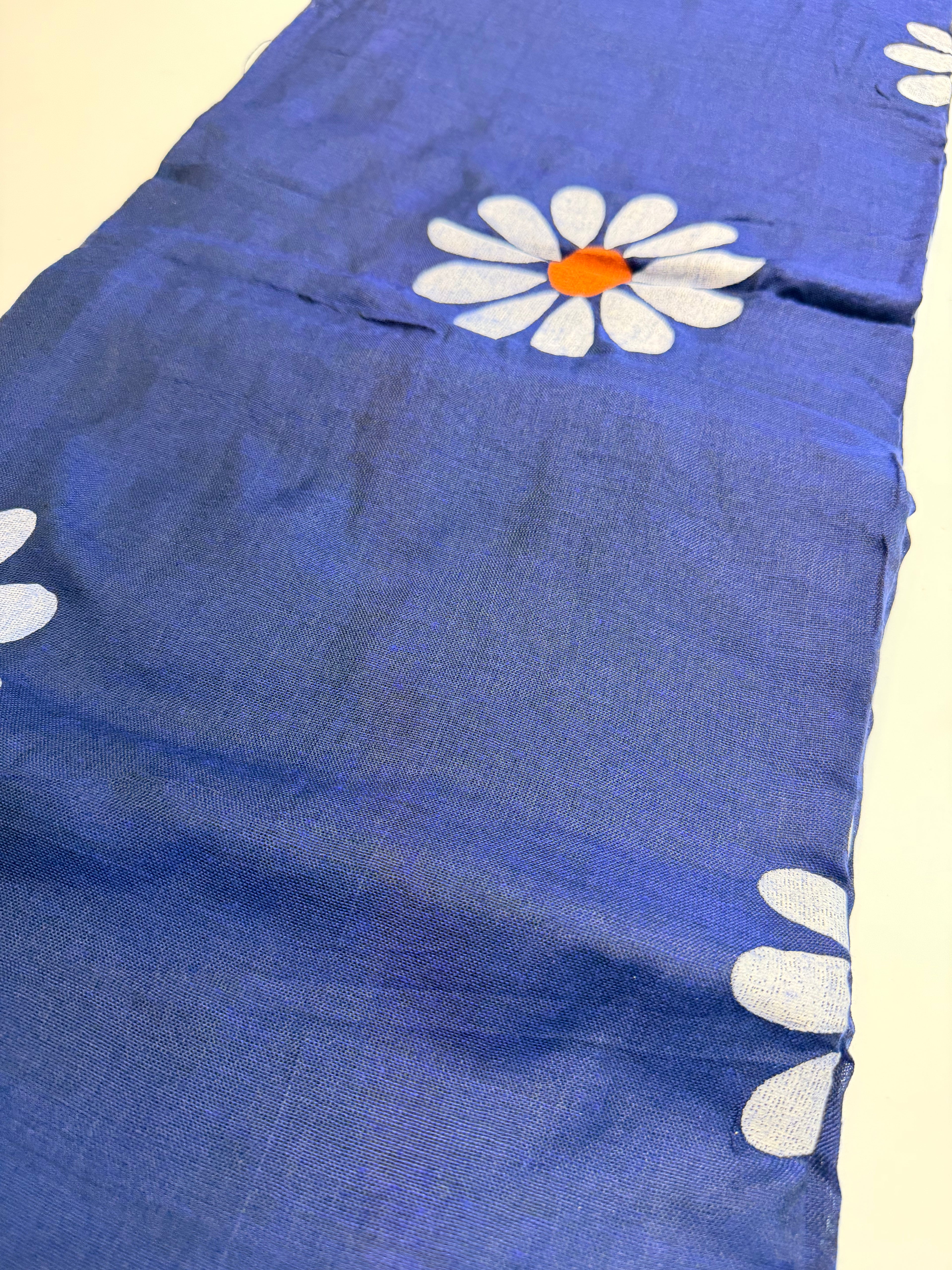 Blue saree with floral patterns.